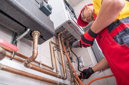 A1 Plus heating technician checking furnace