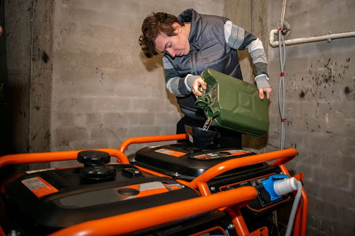 Man filling up generator gas tank.